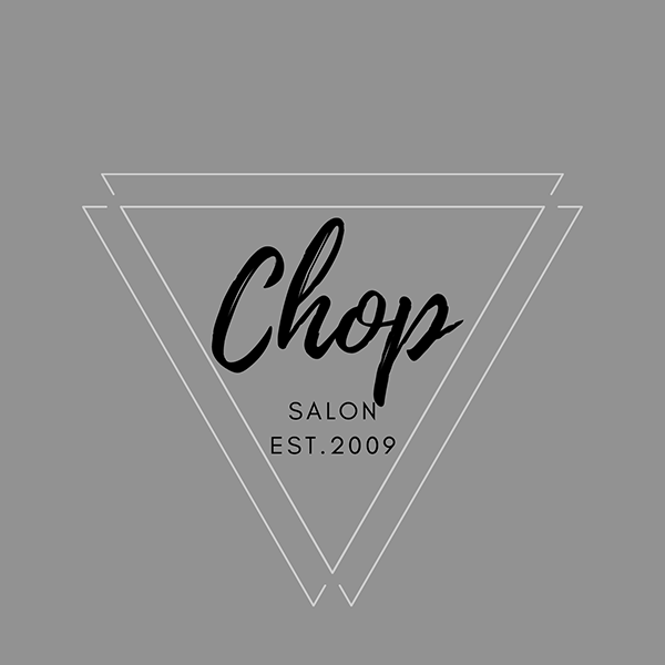 A white triangle graphic with the words Chop Salon, Est 2009 in the center wtih a grey background.